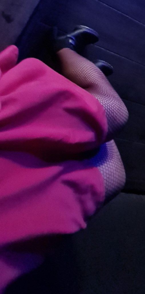 Long legs in the coloured lights of the venue