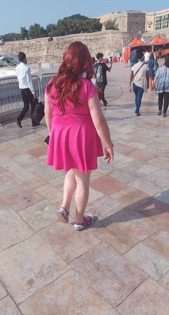 Out in the street walking to the start of the procession. Full length photo from behind.