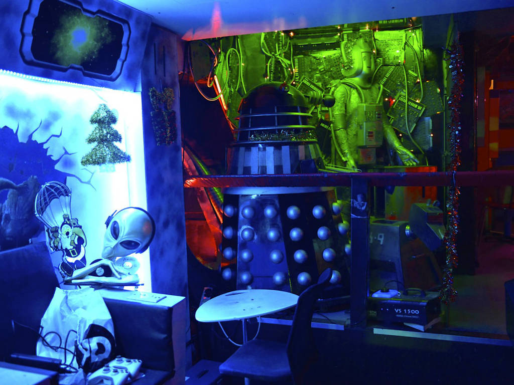 Venue containing lots of SciFi memorabelia; visible are: "grey" alien, Tardis, Cyberman and other less readily identifiable items