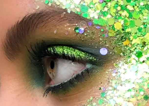 Green and yellow glitter around an elegantly made-up eye