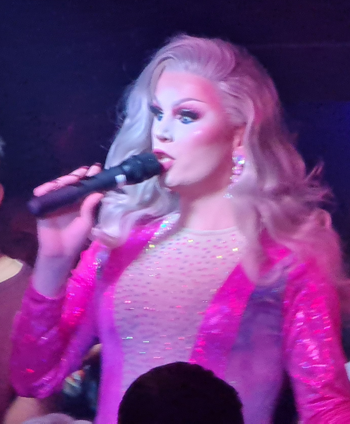 A beautifully made-up diva singing