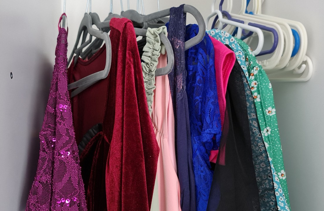 A few of my dresses hanging in a hotel wardrobe